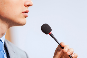 Person speaking into microphone